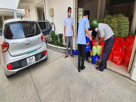 A group of people standing next to a carDescription automatically generated